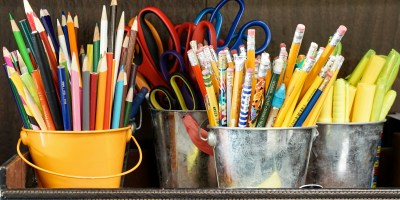 assorted color pencils in yellow bucket